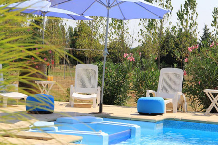 Parasol et transat au bord de la piscine à La Closerie du Chêne Bleu, location de chambres d'hôtes près de Bordeaux